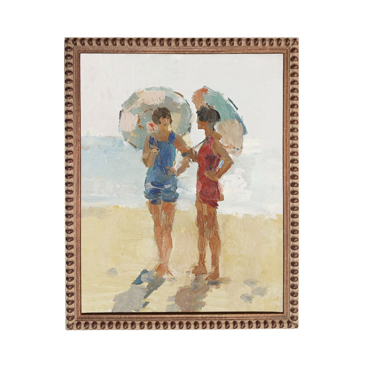 Two women standing on a beach, each holding an umbrella.
