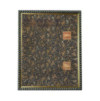 The image is a square frame with a decorative border, featuring a patterned fabric or wallpaper with a dark background and gold accents.