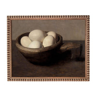 a bowl filled with white eggs, resting on a dark surface.
