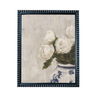 A framed painting depicting a vase filled with white flowers, likely roses, against a light background.