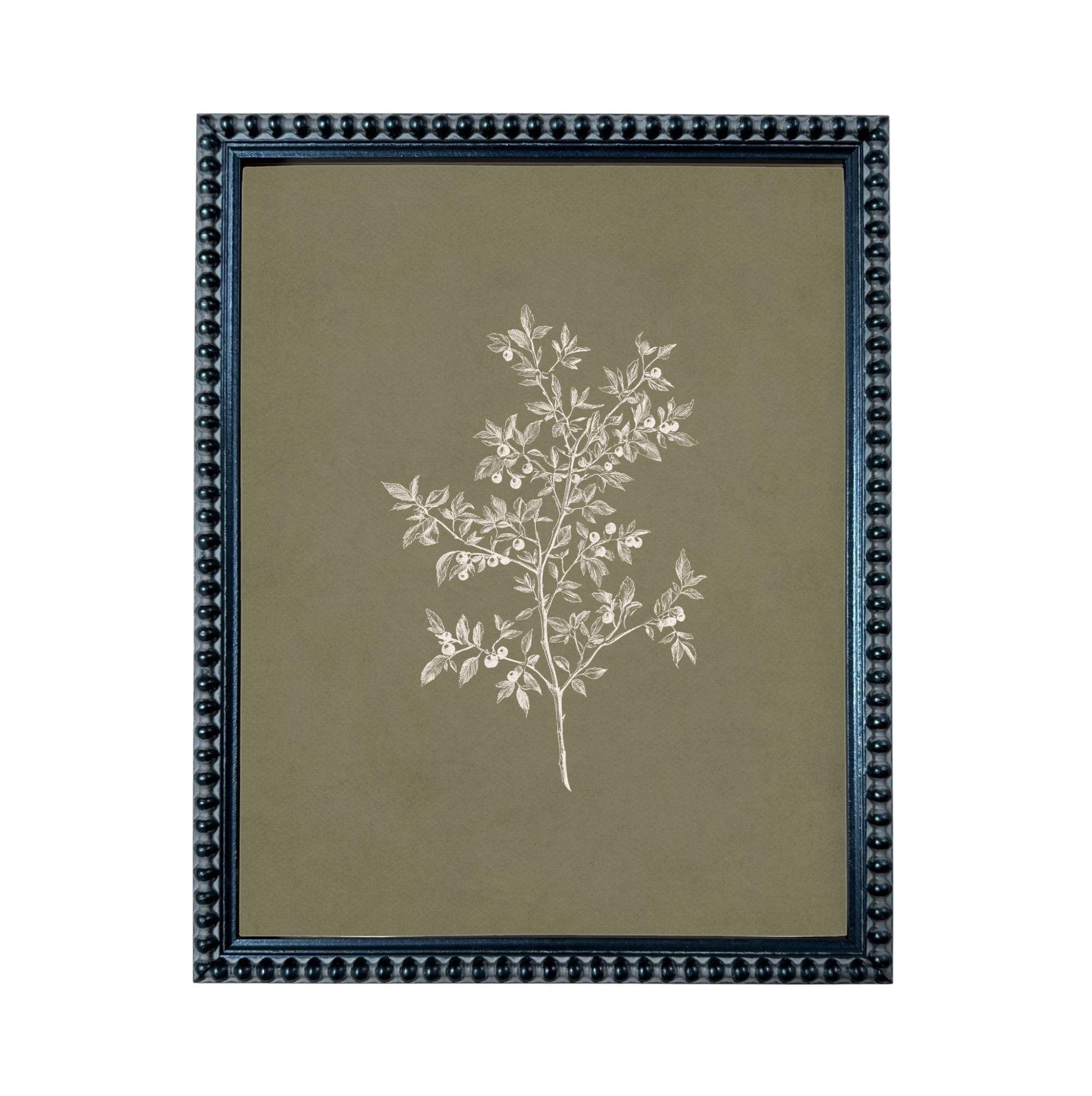 a framed print of a tree with white leaves against a dark green background.