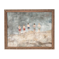 five women walking on a beach, with the ocean in the background.