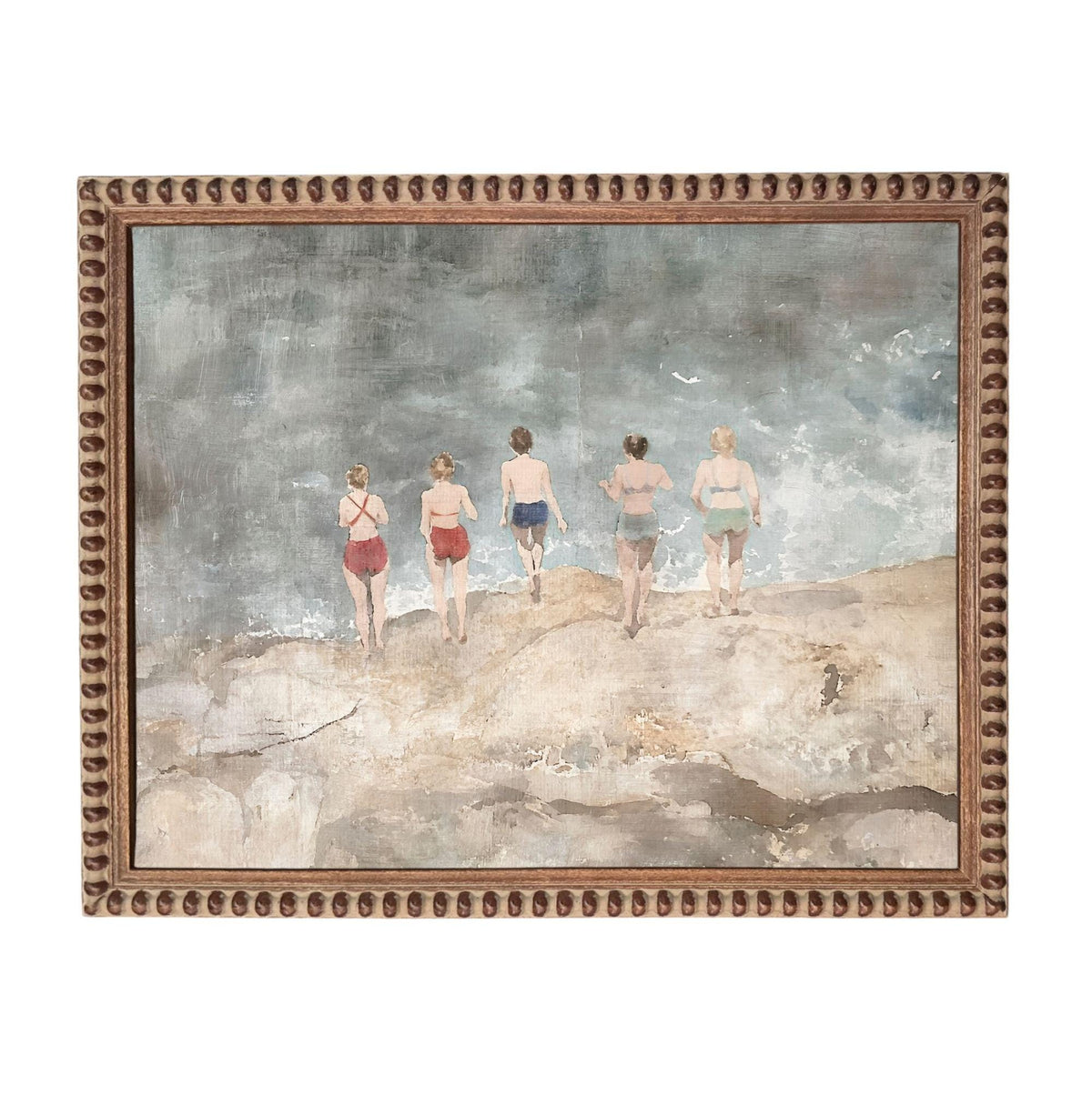 five women walking on a beach, with the ocean in the background.
