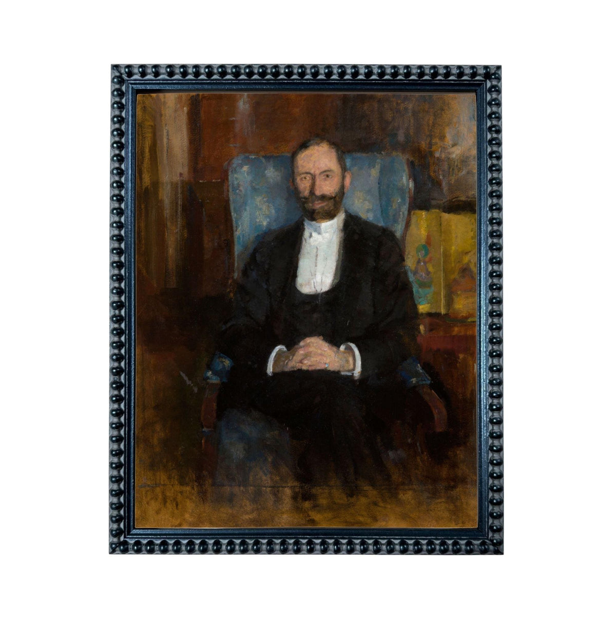 A portrait of a man wearing a suit and tie, sitting in a chair and looking directly at the viewer.