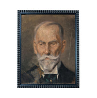 The image is a portrait of an elderly man with a white beard and mustache, wearing a suit and tie.