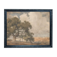 The image is a framed painting depicting a landscape with a large tree in the foreground and a cloudy sky in the background.