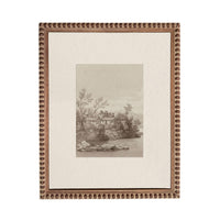 The image is a framed print depicting a serene landscape with a house nestled among trees and a body of water in the background.