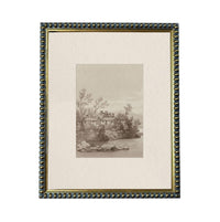 The image is a framed print depicting a serene landscape with a house nestled among trees and a body of water in the background.
