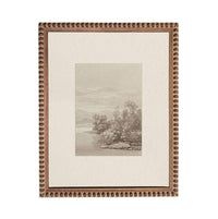 The image is a framed artwork depicting a serene landscape with trees, water, and mountains in the background.