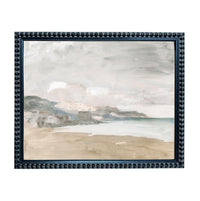 The image is a framed painting depicting a serene coastal landscape with a beach, mountains, and a body of water in the background.