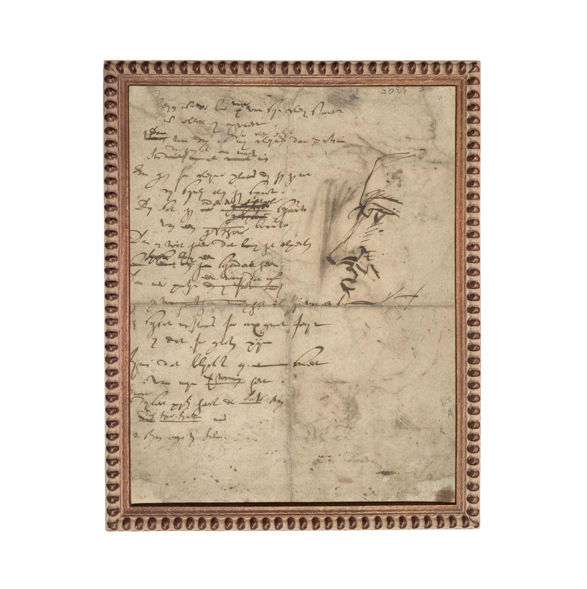 The image is a framed piece of artwork featuring a handwritten note and a sketch of a face.