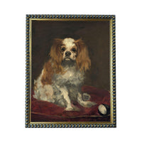 A portrait of a Cavalier King Charles Spaniel dog sitting on a red cushion, with a tennis ball nearby.