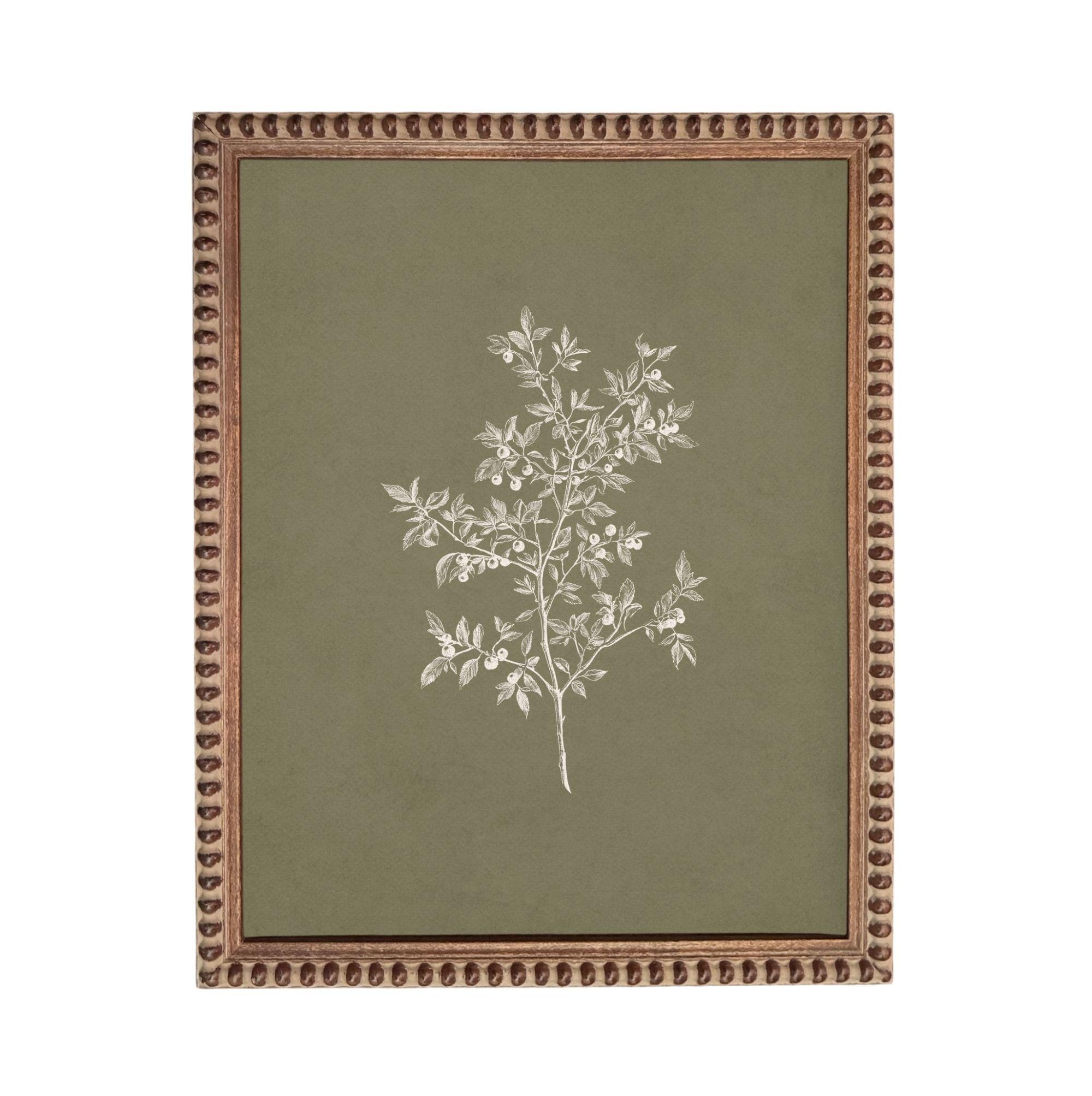 a framed artwork depicting a tree with white leaves against a green background.