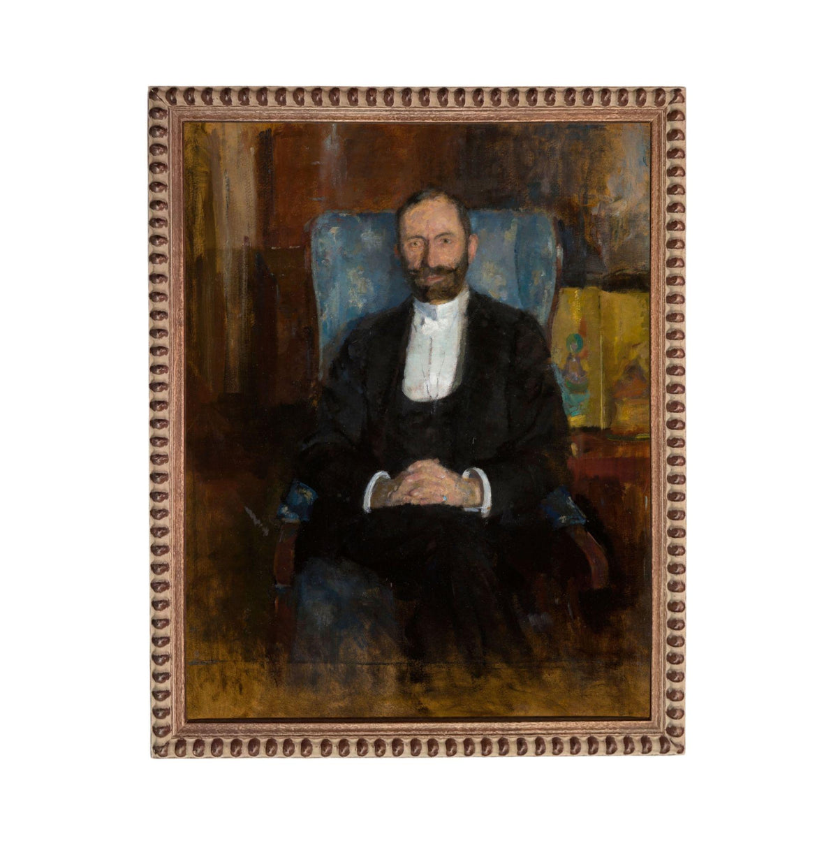 A portrait of a man wearing a suit and tie, sitting in a chair and looking directly at the viewer.