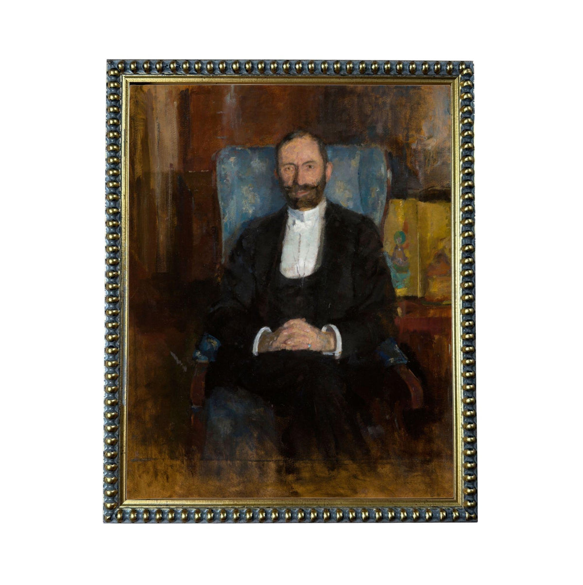 A portrait of a man wearing a suit and tie, sitting in a chair and looking directly at the viewer.