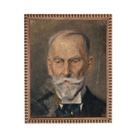 The image is a portrait of an elderly man with a white beard and mustache, wearing a suit and tie.