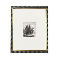 a framed black and white photograph of a tree, with a decorative border around the edges.