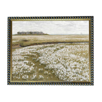 The image is a painting of a field with white flowers, framed in a decorative gold frame.