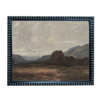 The image is a framed painting depicting a serene landscape with mountains, trees, and a cloudy sky.