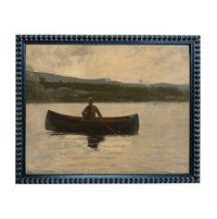 A man is rowing a canoe on a lake, surrounded by a serene landscape of mountains and trees.