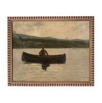 A man is rowing a boat on a lake, surrounded by a serene landscape of mountains and trees.
