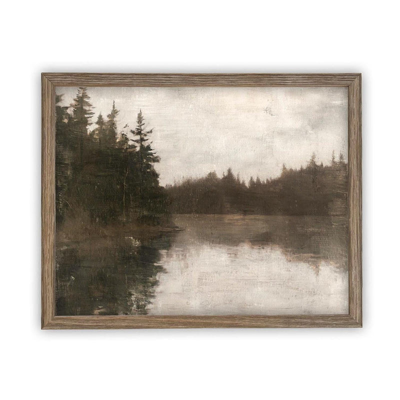 May include: A framed landscape painting depicting a serene lake scene. The artwork features a muted color palette of gray, brown, and white, with a reflection of the trees in the water. The frame is made of light brown wood.